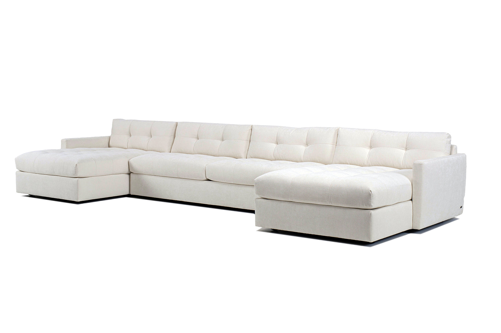 A white, low profile Carmet sectional sofa with wide track arms and a sleek modernist look.